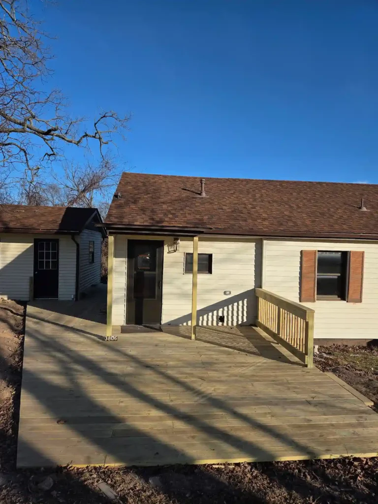 Small house with wooden accessibility ramp.